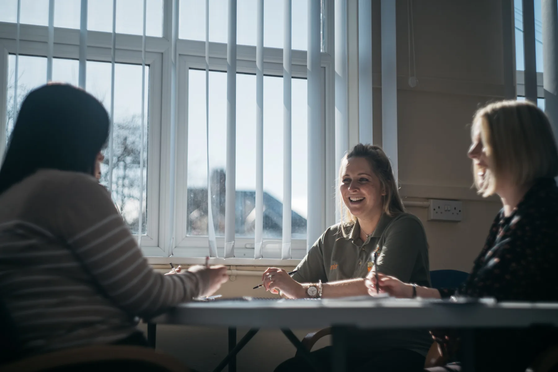 Women Laughing During A Meeting