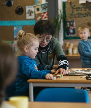 Nursery Teacher and Child in Class