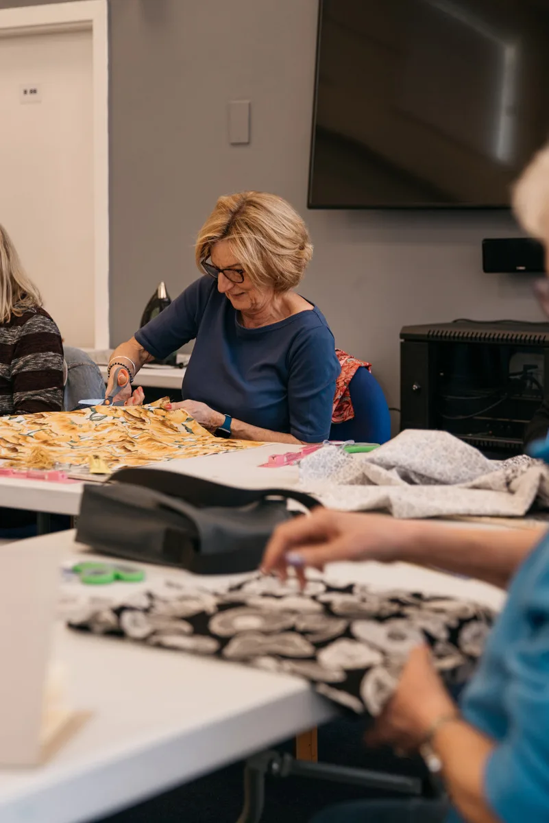 Woman Cutting Paper With Scissors