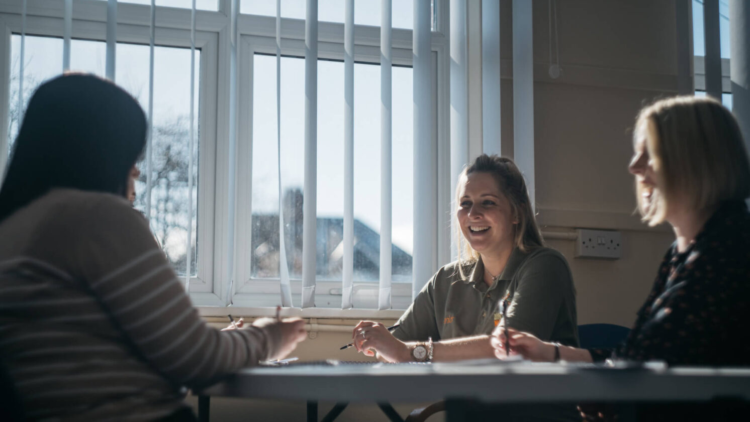 Three Women Laughing during Meeting