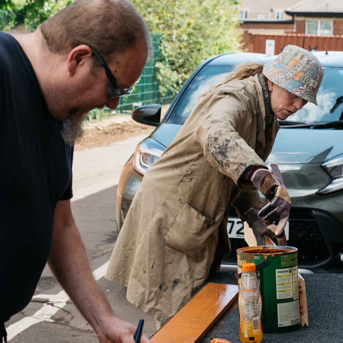 Man and Woman Painting Plank of Wood Together