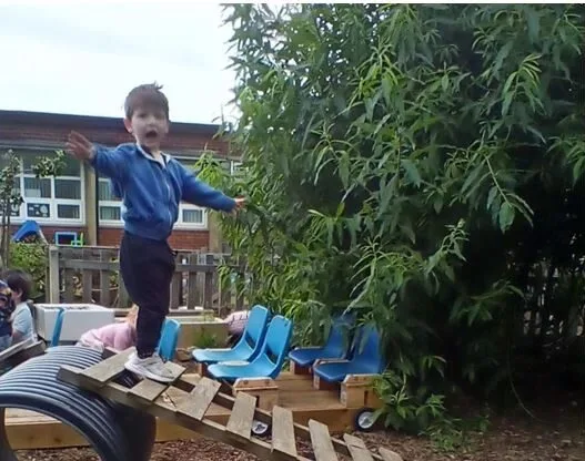A Child Balancing on Wooden Playground